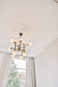 a chandelier hangs from the ceiling in front