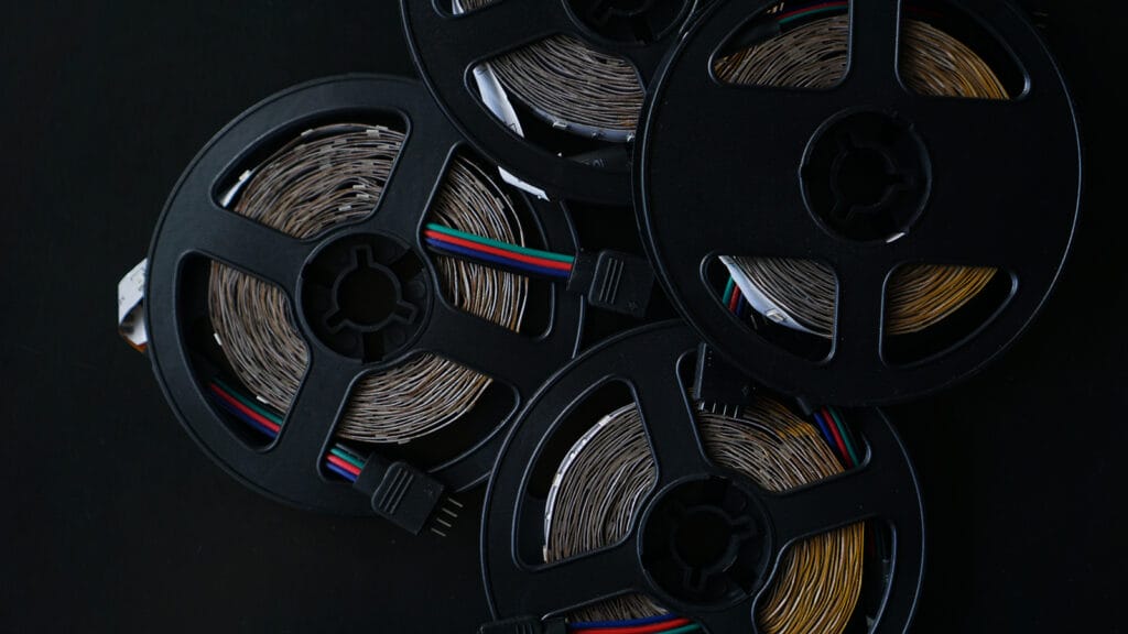 Coils Of Rgb Led Strip On A Black Table. Led Strip For Creative Lighting