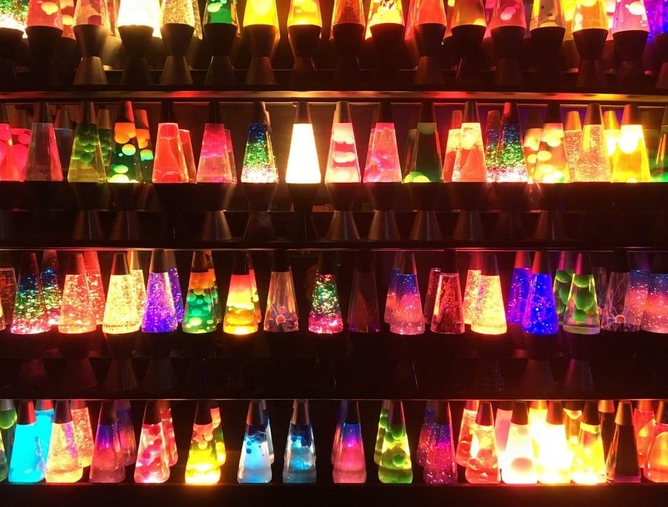 A collection of lava lamps in a shell with beautiful glowing colors.