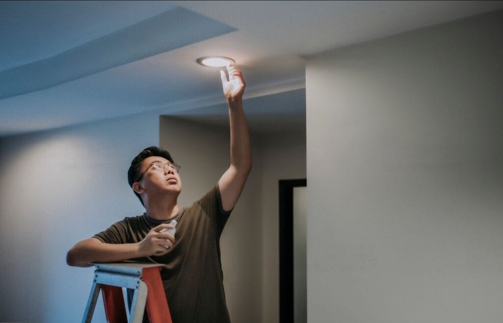 A man familiarizing the steps in replacing the bulb and light fixture.