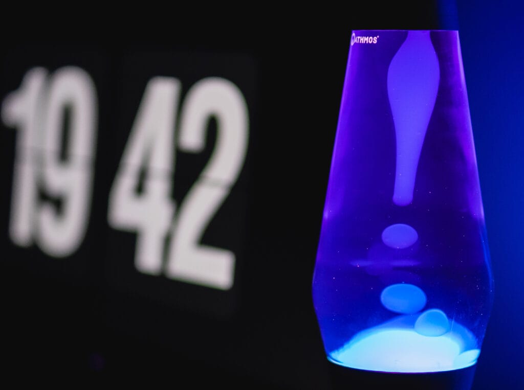 An indigo Lava Lamp with a blurry time display on the side.